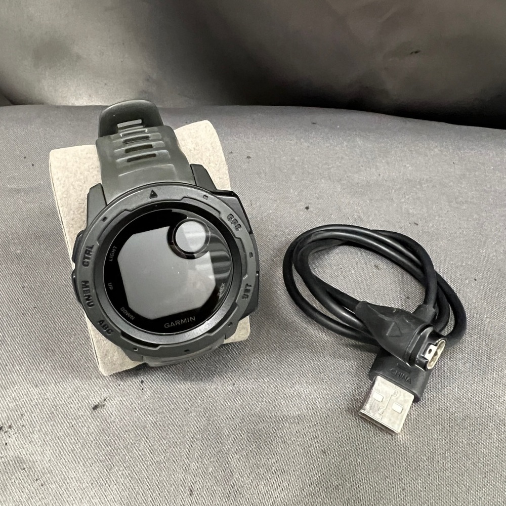 Garmin Graphite rugged GPS watch with charging cable
